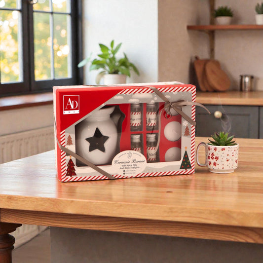 Kit candele brucia oli essenziali, ambientato in una casa accogliente e festiva.