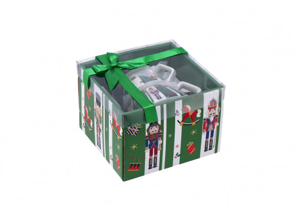 Scatola regalo con fiocco con kit teiera impilable verde su uno sfondo bianco.